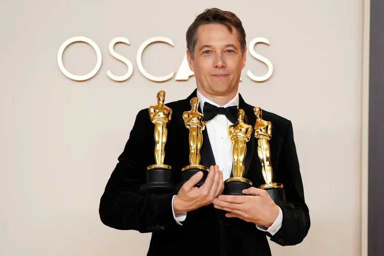 Sean-Baker-Poses-with-his-four-academy-Awards